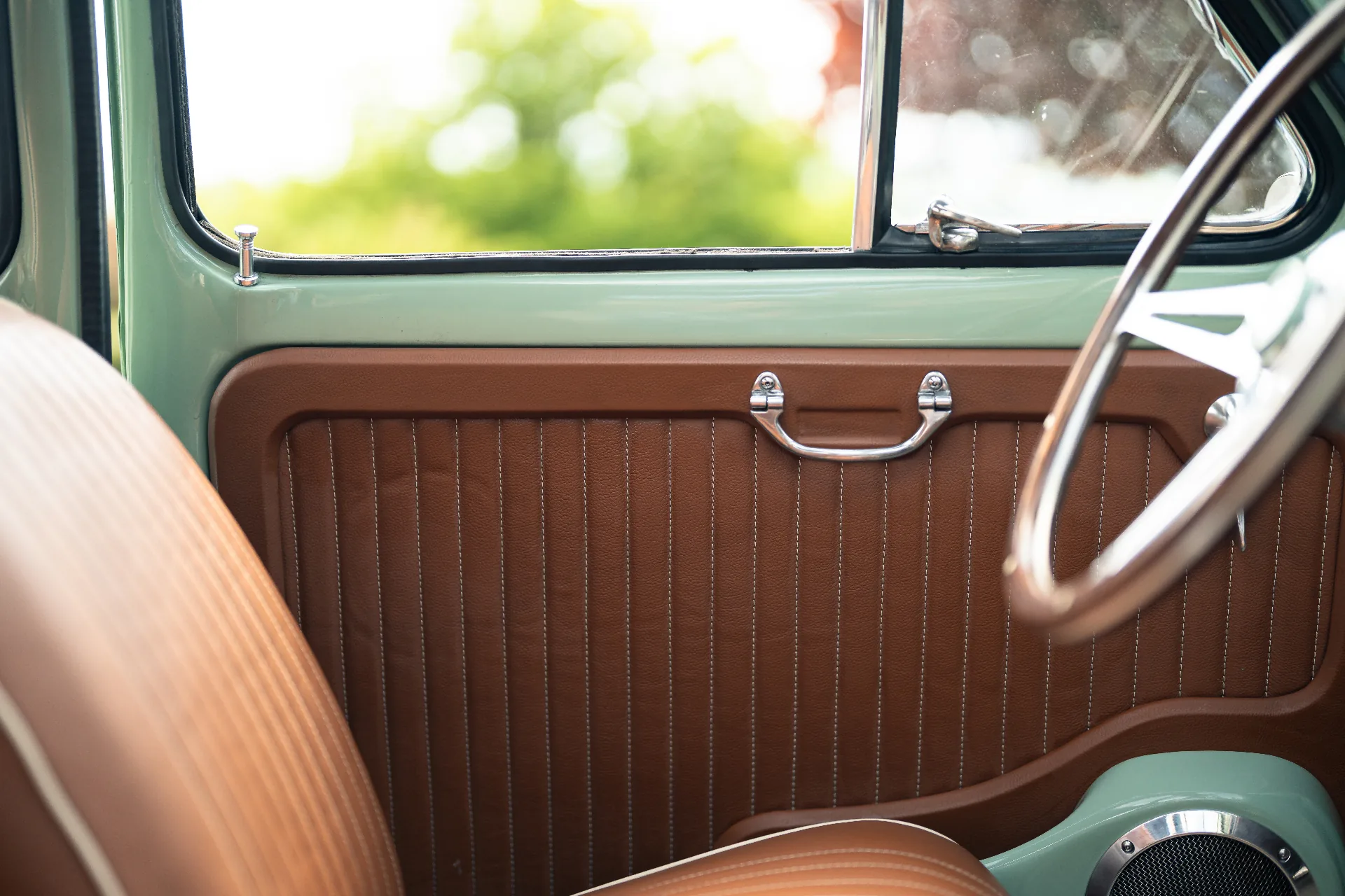 Cognac leather door card with vertical stitched pleats and chrome handle