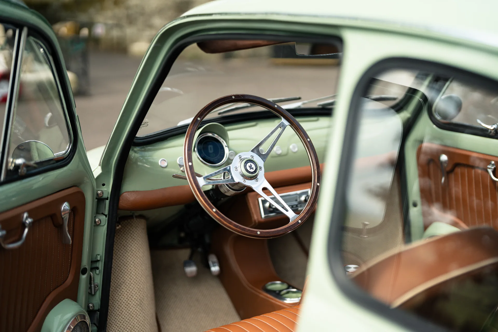 Mint cabin with cognac leather and polished three-spoke wood steering wheel